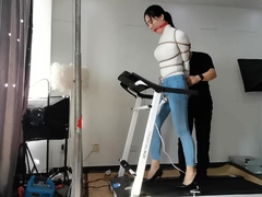 Bound and gagged Asian babe walks on treadmill in high heels