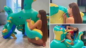 Nastya blowing hard her huge inflatable dragon