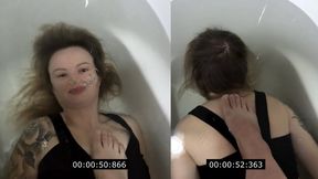 Anastasia is underwater with a foot on her