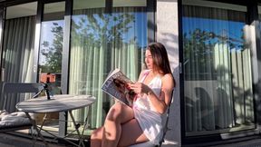 Wonderfully beautiful girl in a summer dress no panties on the balcony shows her tight shaved pussy to the neighbors