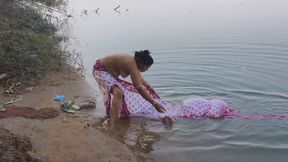 Indian village wife bathing in the river in outdoor area