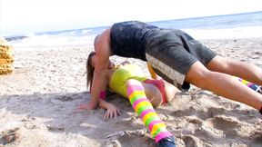 Fitness coach pamper client at beach